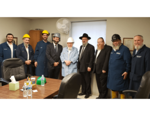 Picture of David Elliot owners with Rabbi Klarberg.