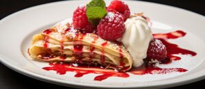One idea is to fill the egg crepe with strawberries, raspberries, and whipped cream and drizzle it with raspberry sauce. 